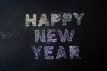 a happy new year written on a black background